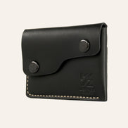 MZ Leather Craft siyah Buttero deri kapaklı minimalist cüzdan, kapalı hafif açılı sağ profil görünümü, çift çıtçıt detayı ve asimetrik kapak yapısı