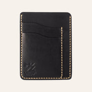 MZ Leather Craft dikey minimalist siyah Buttero deri kartlık, boş kart yuvalarını ve pürüzsüz deri dokusunu gösteren düz ön görünüm, sarı el dikişleri ve kabartmalı MZ logosu
