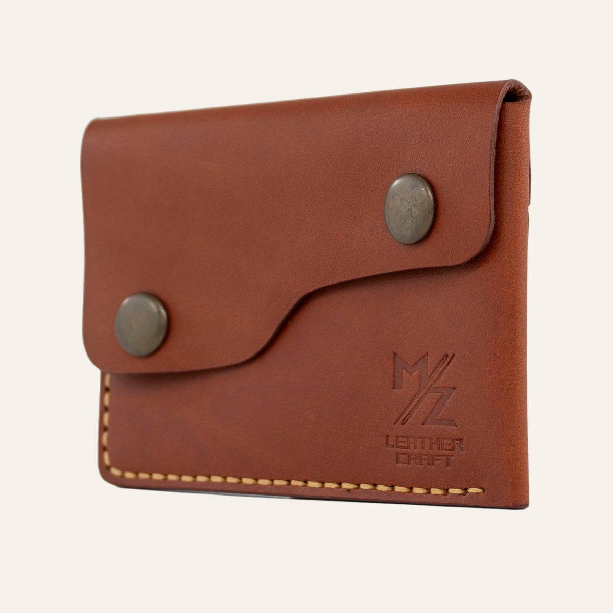 MZ Leather Craft kiremit Buttero deri kapaklı minimalist cüzdan, kapalı hafif açılı sağ profil görünümü, çift çıtçıt detayı ve asimetrik kapak yapısı